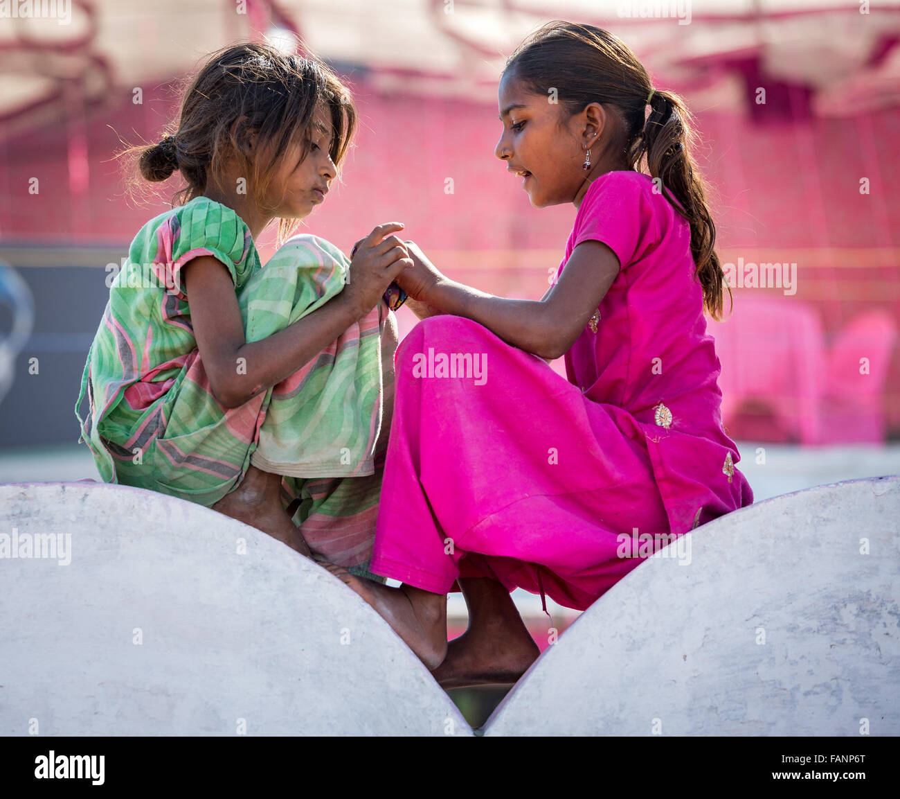 Zwei arme Mädchen sitzt auf einer Mauer, Porträt, Pushkar, Rajasthan, Indien Stockfoto