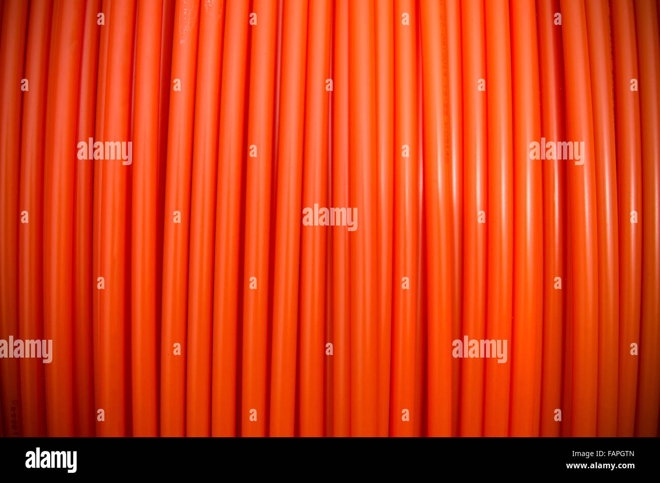 Hintergrund einer Rolle orange Glasfaserkabel Stockfoto