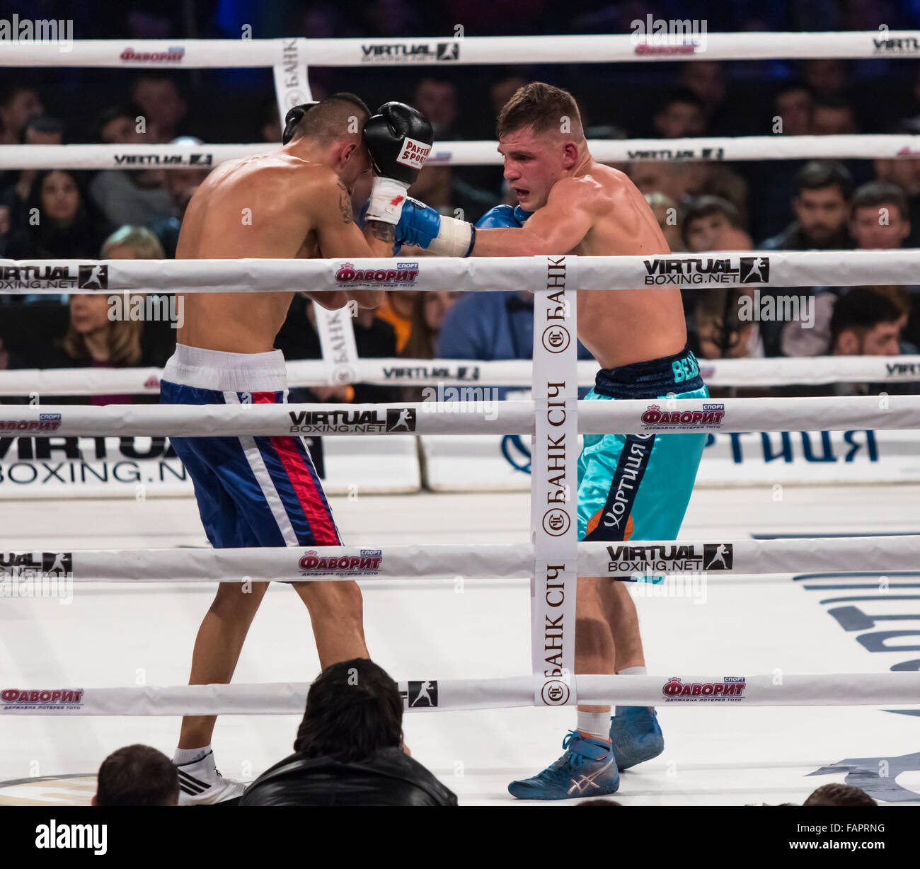 Kiew, UKRAINE - 12. Dezember 2015: Denys Berinchik der Ukraine (himmelblaue Shorts) Kämpfe mit György Mizsei (Ungarn) während der "Abend des Boxens" im Palace of Sports in Kiew Stockfoto