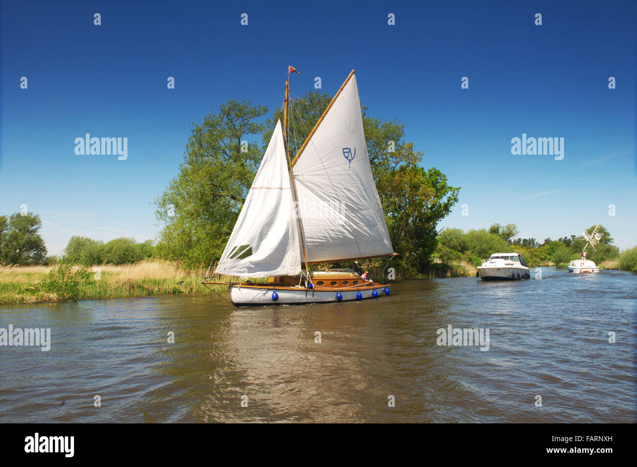 Schönen sonnigen Tag auf dem Fluss Ant wie Hill in Norfolk, als Entscheidungsträger Segeln auf einem Broads Cruiser genießen Urlaub Stockfoto