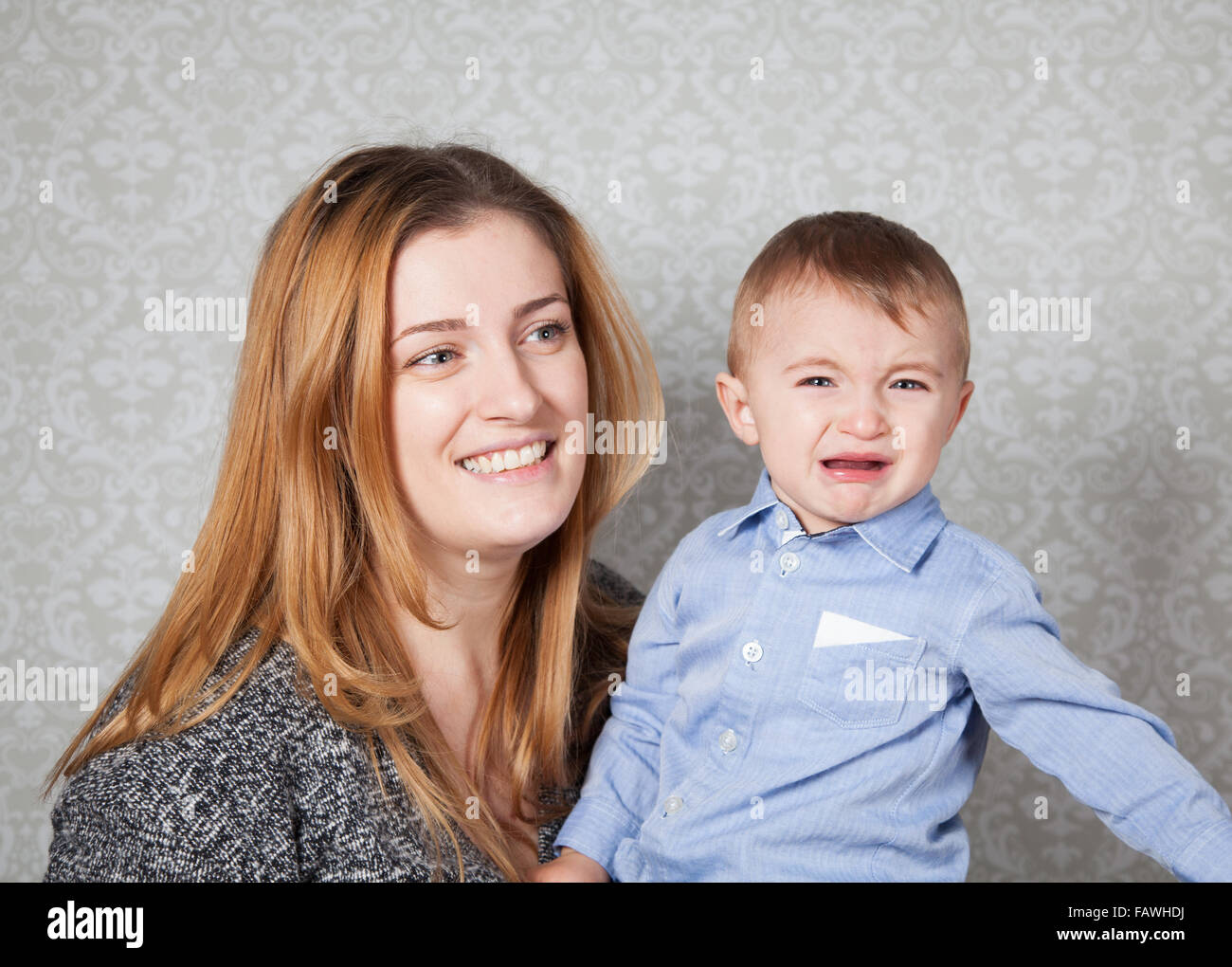 1 Jahre alten Jungen in den Armen seiner Mutter, Studio-Porträt. Stockfoto