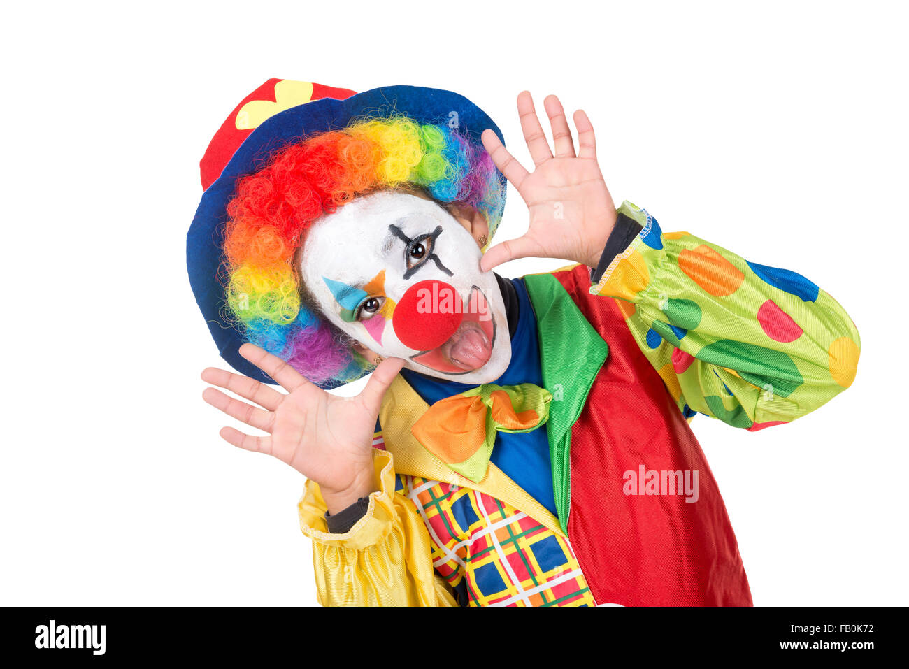 Junges Mädchen mit Clownskostüm isoliert in weiß Stockfoto