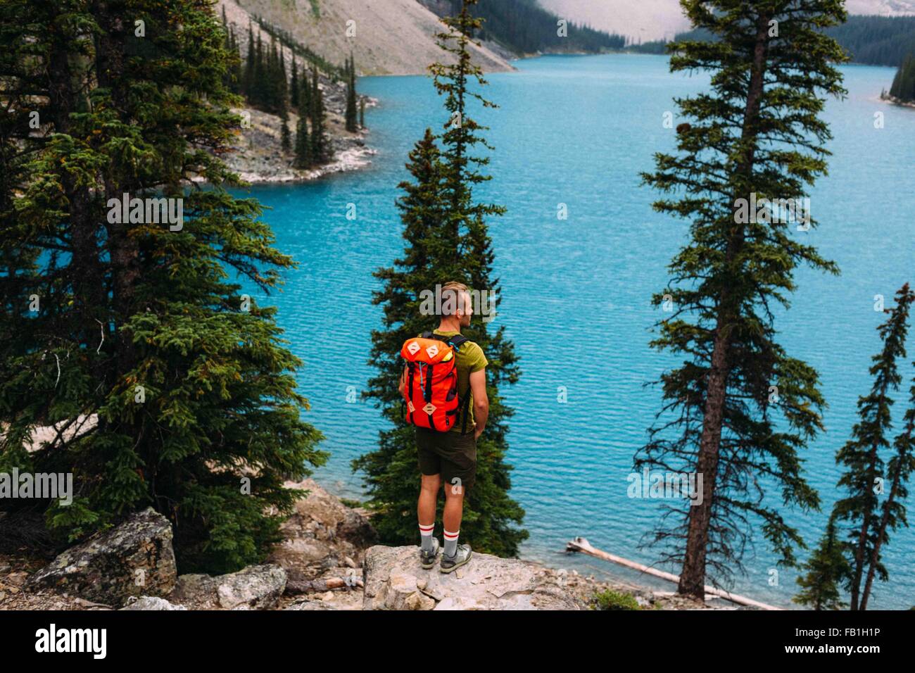 Rückansicht des Mitte erwachsenen Mann auf Klippe erhöhten betrachten der Moraine Lake, Banff Nationalpark, Alberta Kanada Stockfoto
