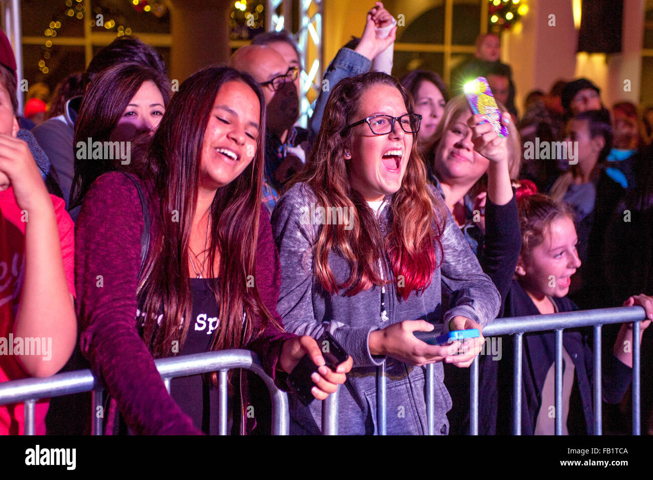 Ein Rock-Konzert am Weihnachtsfest in einem Einkaufszentrum in San Clemente, CA, aufgereiht an einer Schranke, aufgeregte Teenagermädchen anhören. Stockfoto
