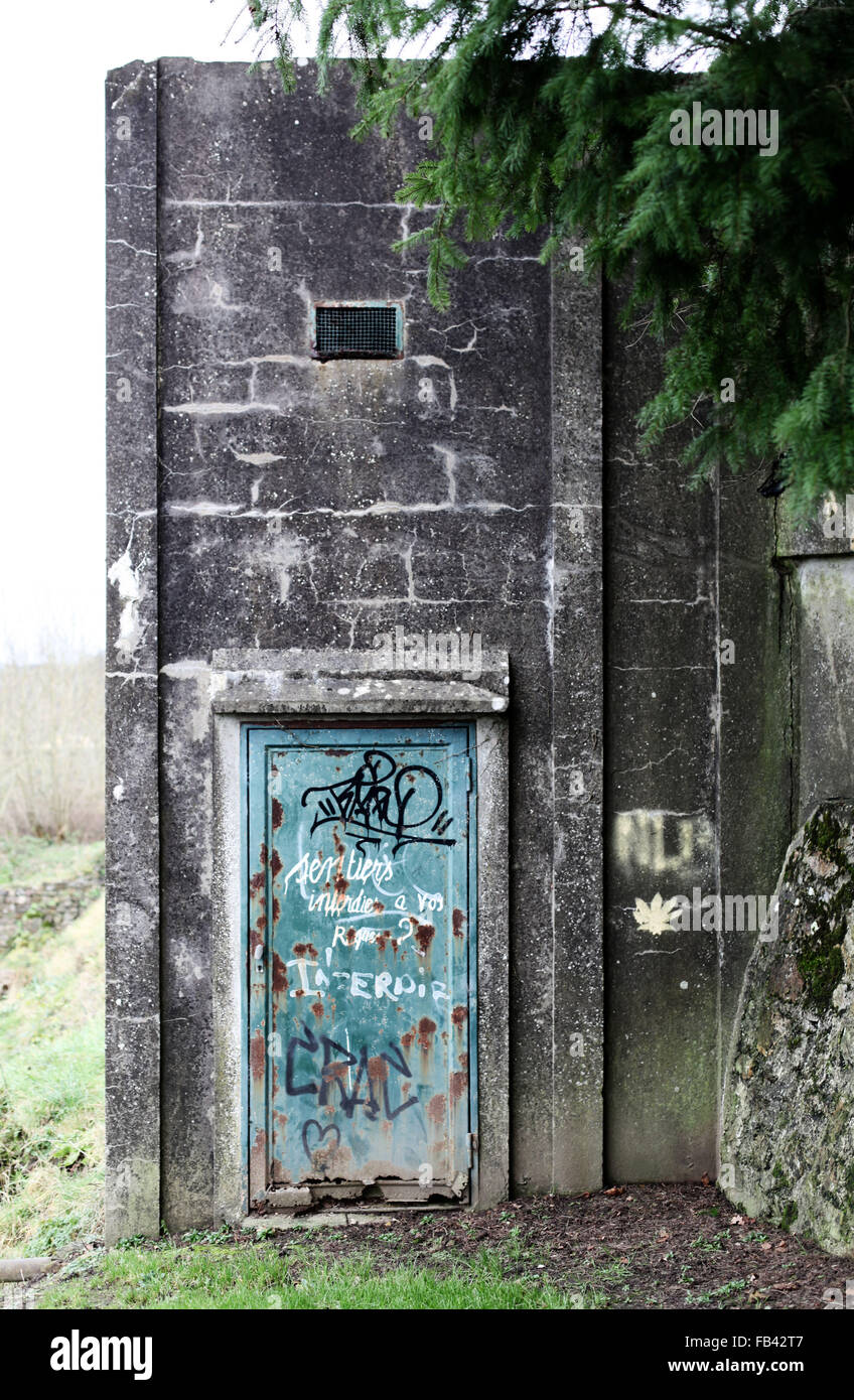 Es ist ein Foto von einem verlassenen Bau aus Beton oder Zement. Wee siehe eine grüne verrostete Tür Stockfoto