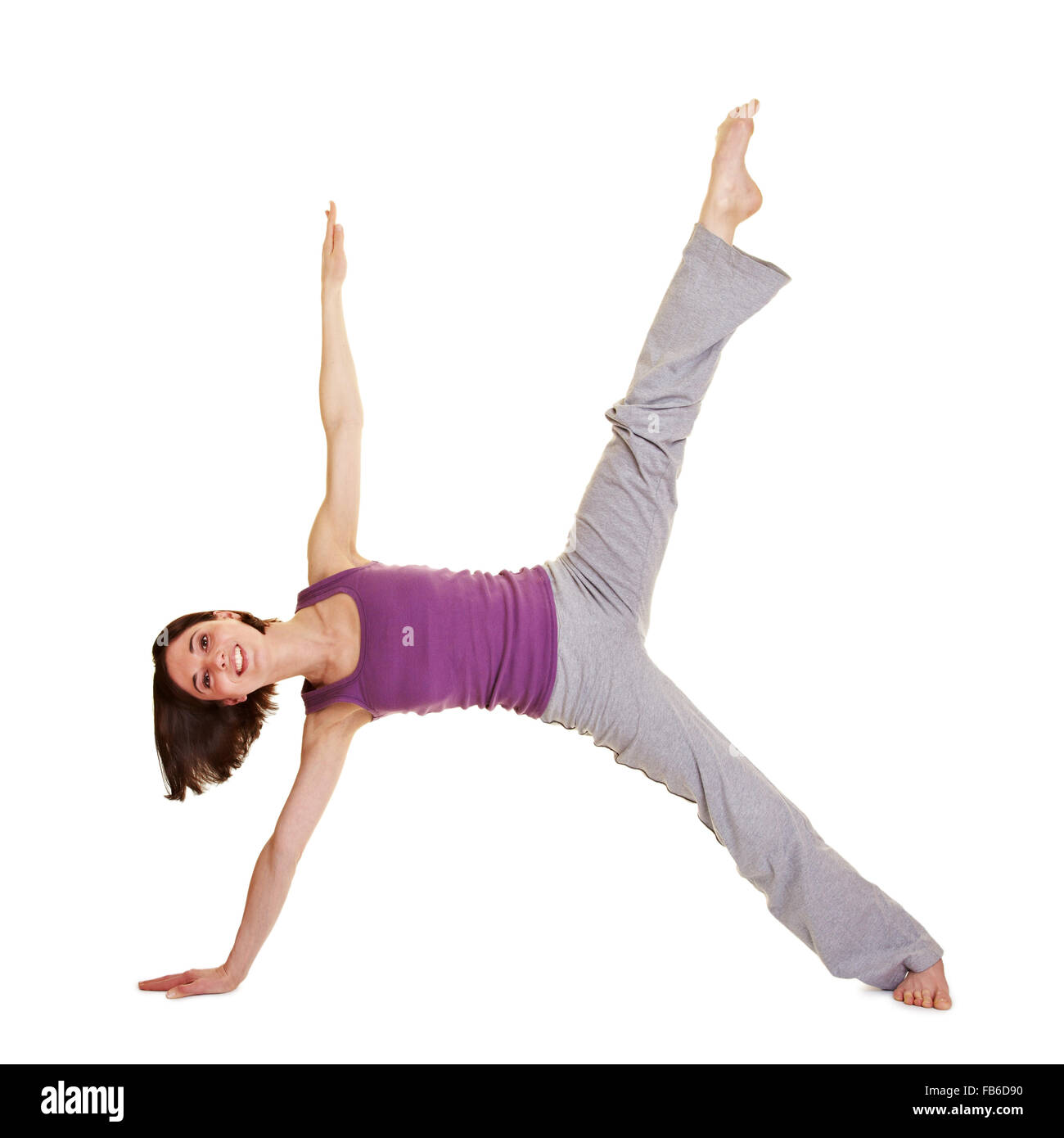 Junge lächelnde flexible Frau ihre Beine Stockfoto