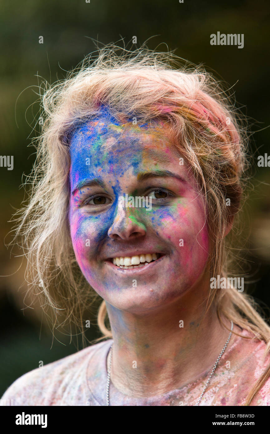 Ziemlich junges Mädchen mit ihrem Gesicht spritzte mit bunten Farbe nach der Teilnahme an der Farbe Run Stockfoto