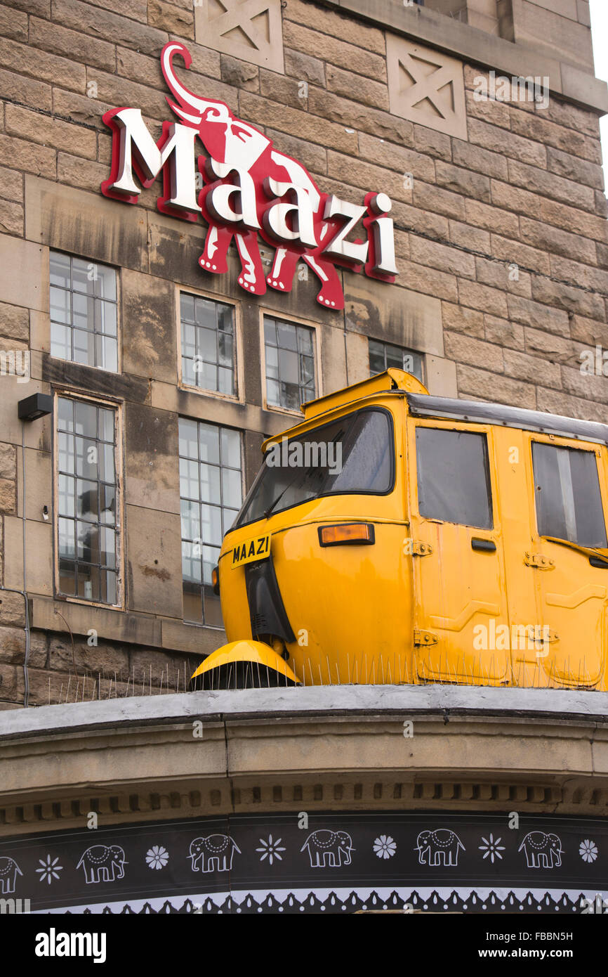 Großbritannien, England, Derbyshire, Matlock, gelb Bajaj Autorikscha auf Veranda des Maazi Indian Restaurant im ehemaligen Kino-Gebäude Stockfoto