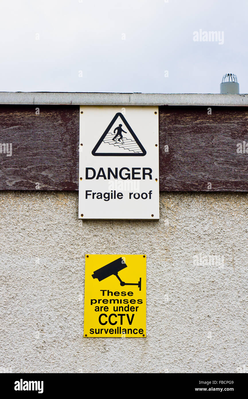 Warnzeichen auf ein Gebäude für eine fragile Dach und Videoüberwachung Stockfoto