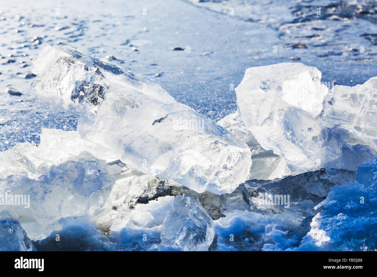 Eisblöcke beleuchtet von Sun am Rande des Eisloch im zugefrorenen See in kalten Wintertag Stockfoto