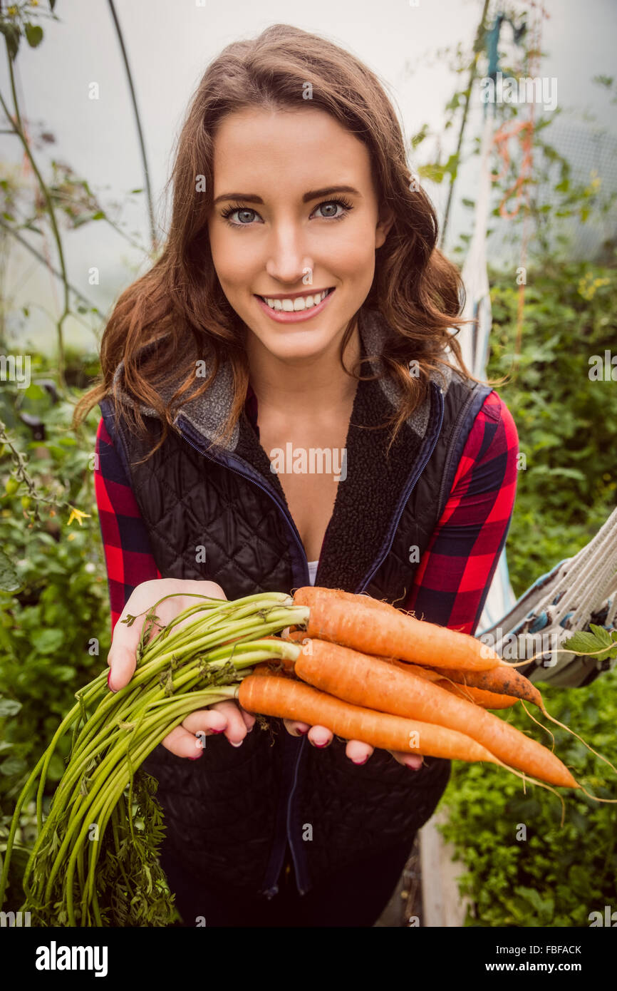 Lächelnde Frau mit Karotten Stockfoto