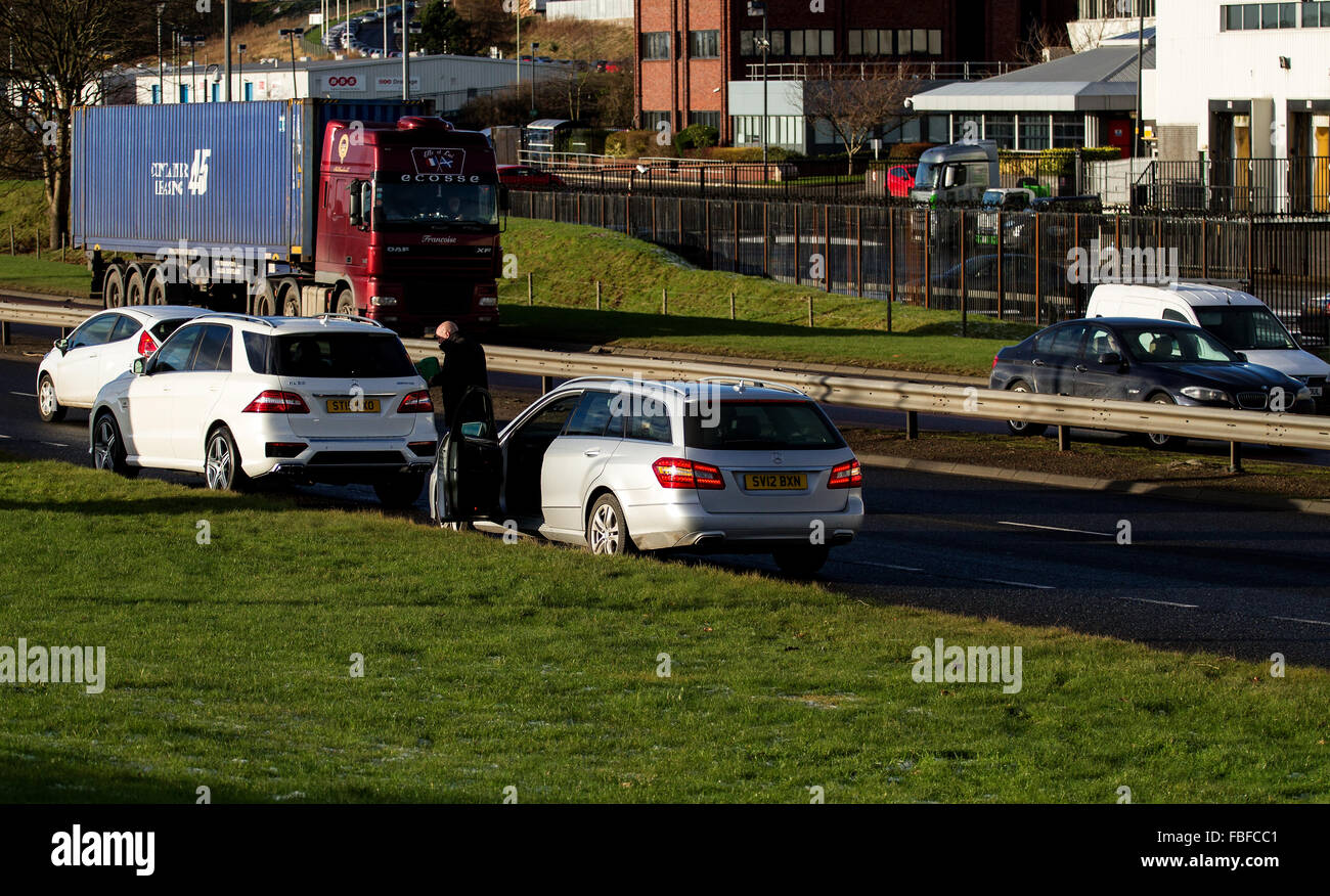 Autofahrer, die Aufstockung eines Mercedes-Benz Autos mit Benzin auf der belebten zweispurigen Straße in Dundee, UK Stockfoto