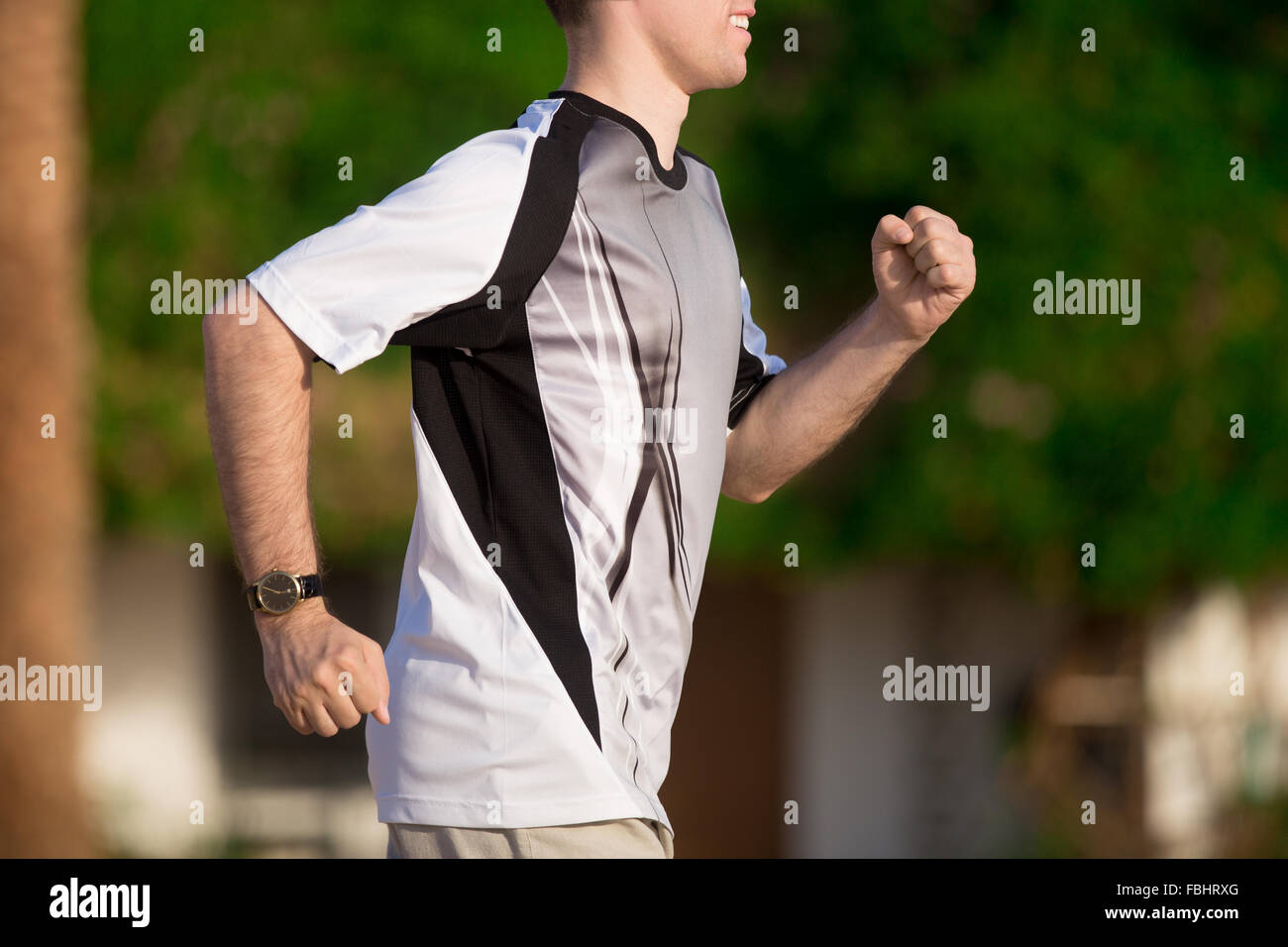 Gesunde Lebensweise: jungen sportlichen Mann im Freien arbeiten, Joggen im Sommer sonnigen Park, close-up, Seitenansicht Stockfoto