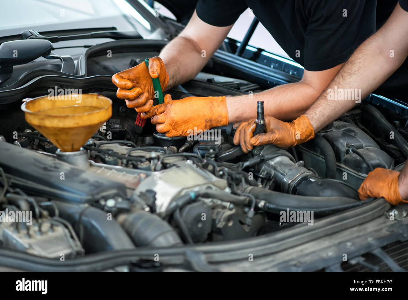 Zwei Mechaniker arbeitet an einem Fahrzeug in einer garage Stockfoto