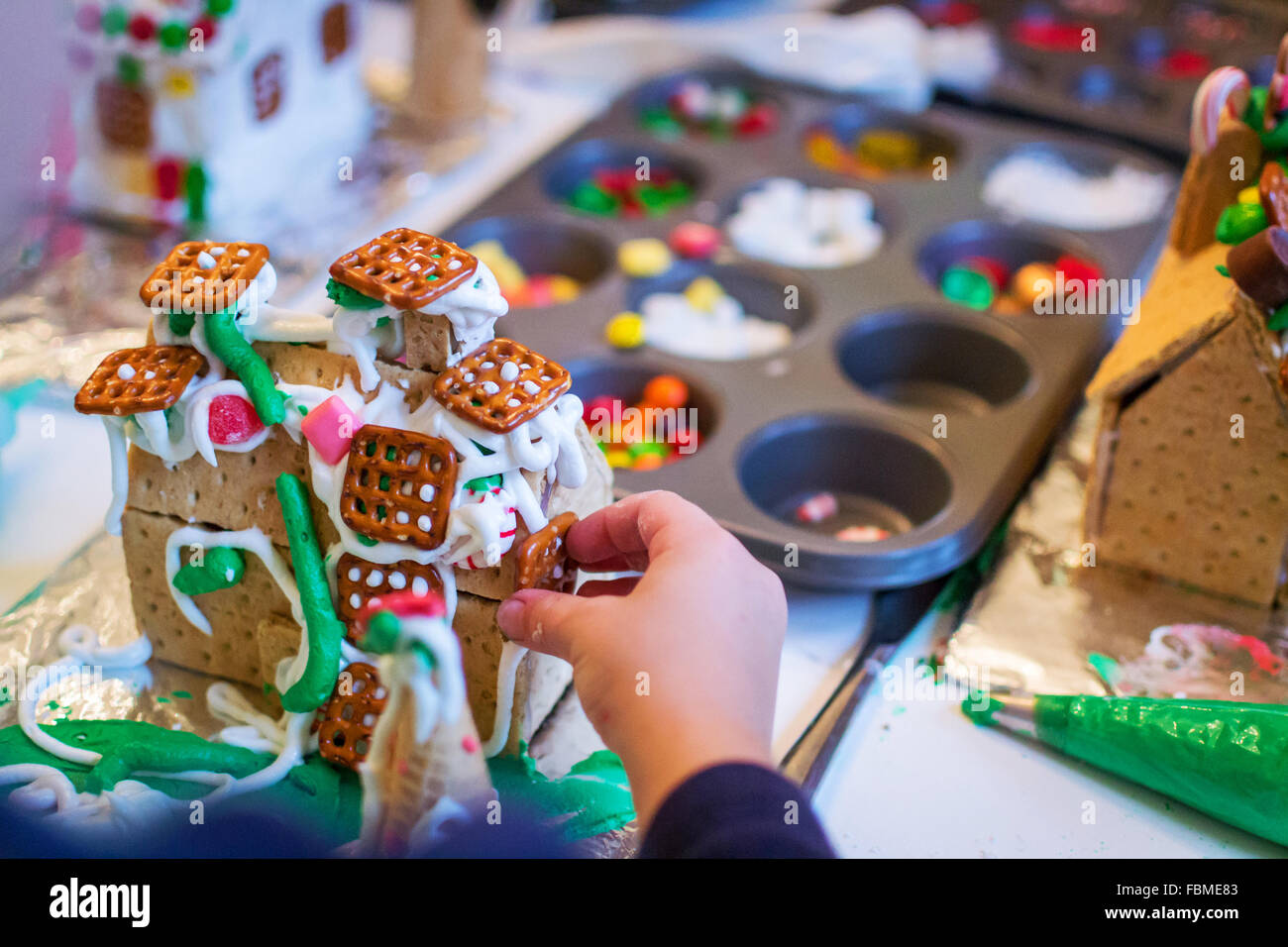 Junge dekorieren ein Lebkuchenhaus Stockfoto