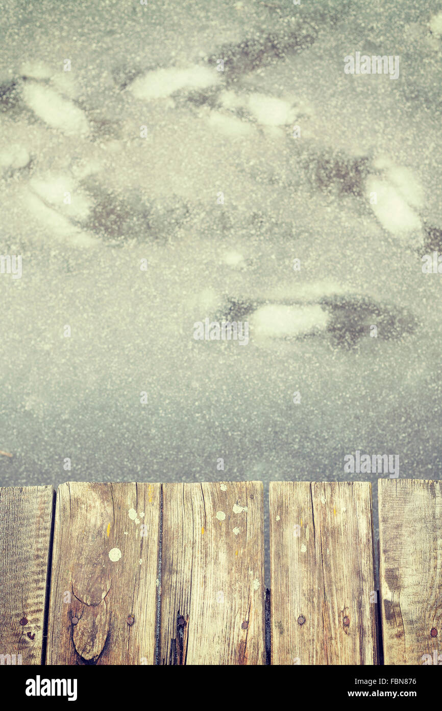 Retro getönten alte hölzerne Pier auf Eis, abstrakten Hintergrund mit Platz für Text. Stockfoto