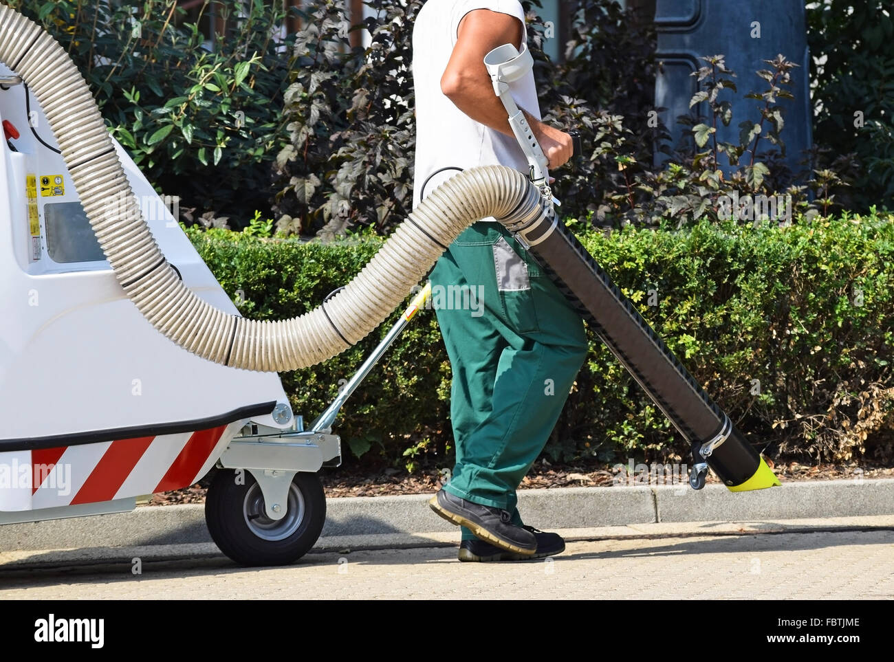 Straße sauberer arbeitet mit einem Vacum cleaner auf der Straße Stockfoto