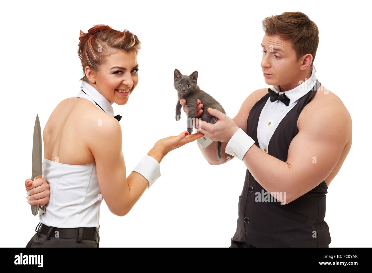 Vertrauensvolle Kerl gibt Kätzchen zu irreführenden Mädchen Stockfoto