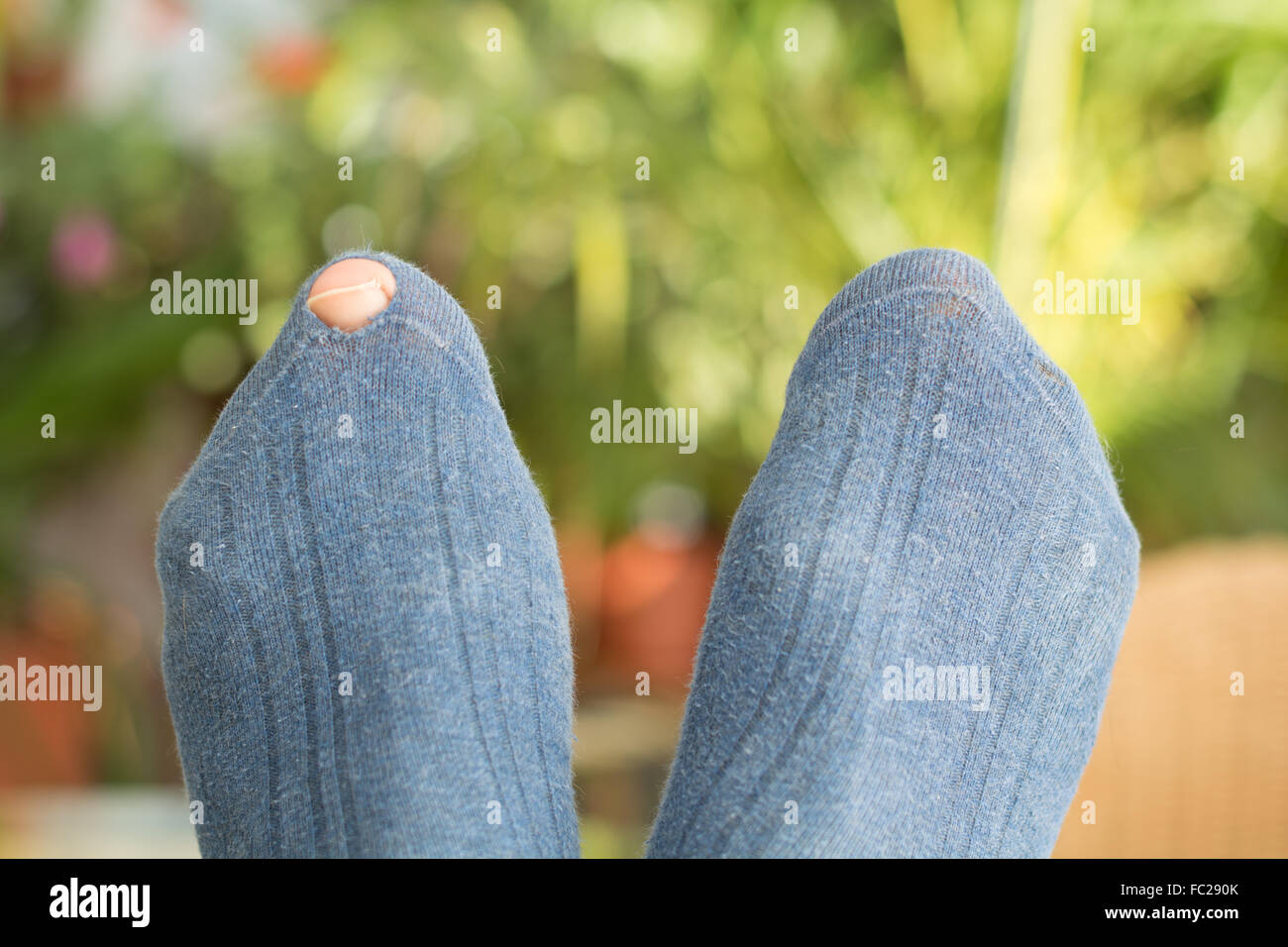Zeh durch Loch in eine Socke Stockfoto
