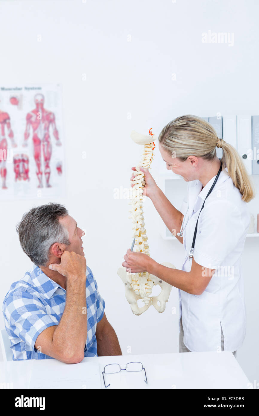 Arzt zeigen anatomische Wirbelsäule zu ihrer Patientin Stockfoto