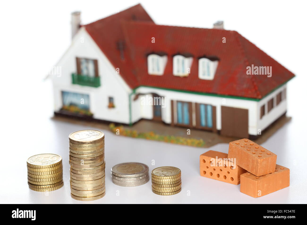 Haus Ziegel und Geld Stockfoto