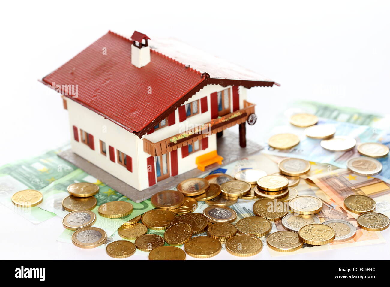 Euro-Münzen und Haus Stockfoto