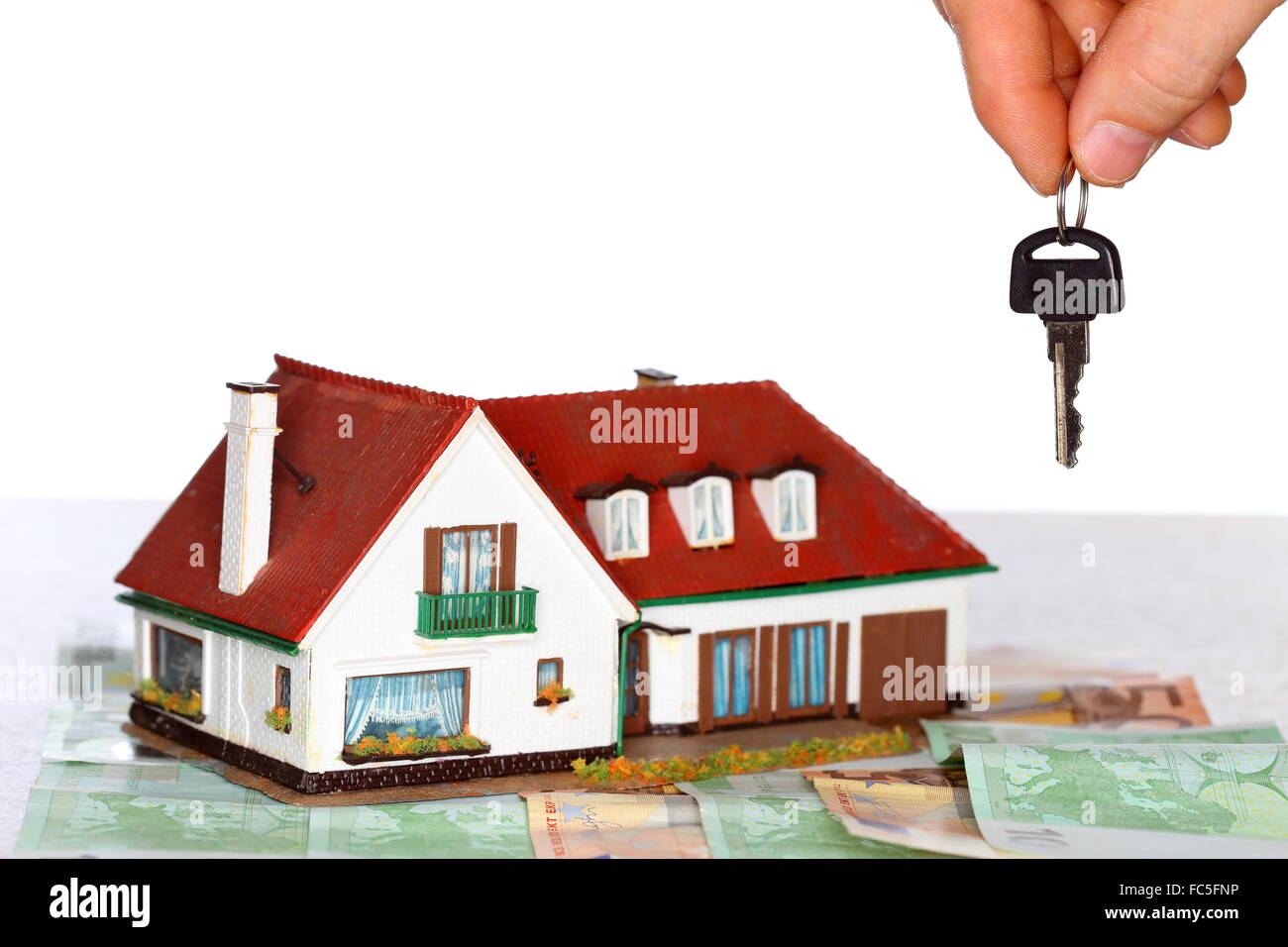 Schlüssel, Geld und Haus Stockfoto