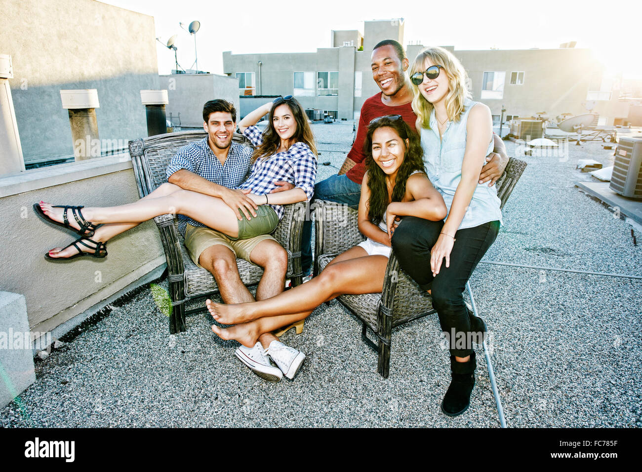 Freunde auf städtische Dachterrasse entspannen Stockfoto