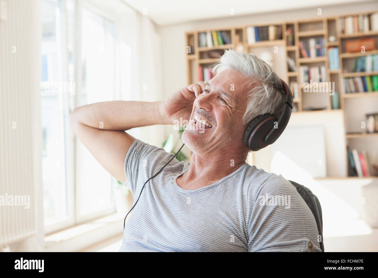 Porträt des entspannten Menschen hören Musik Kopfhörer zu Hause Stockfoto