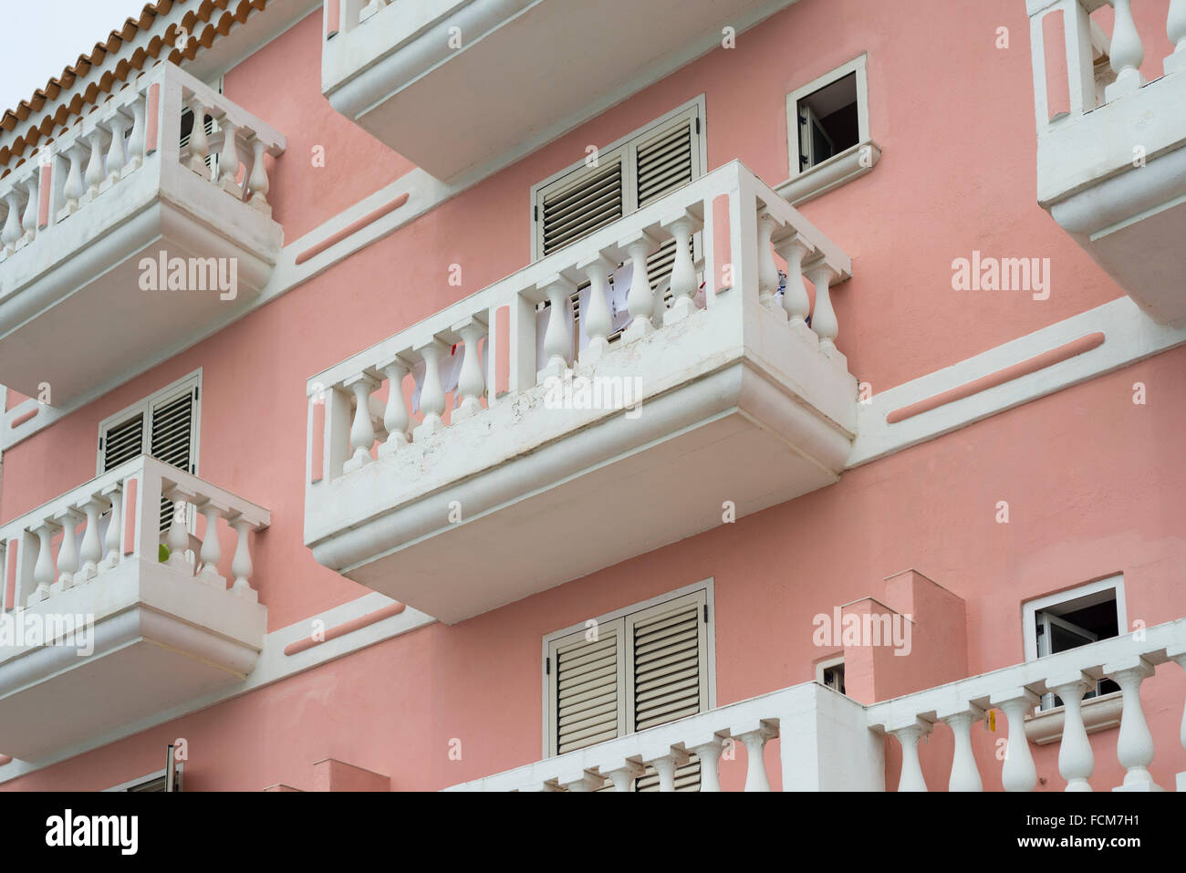 Weißen Balkonen und Jalousien auf der lachsfarbenen Fassade eines mediterranen Hauses in der Cilento-Region im Süden Italiens Stockfoto