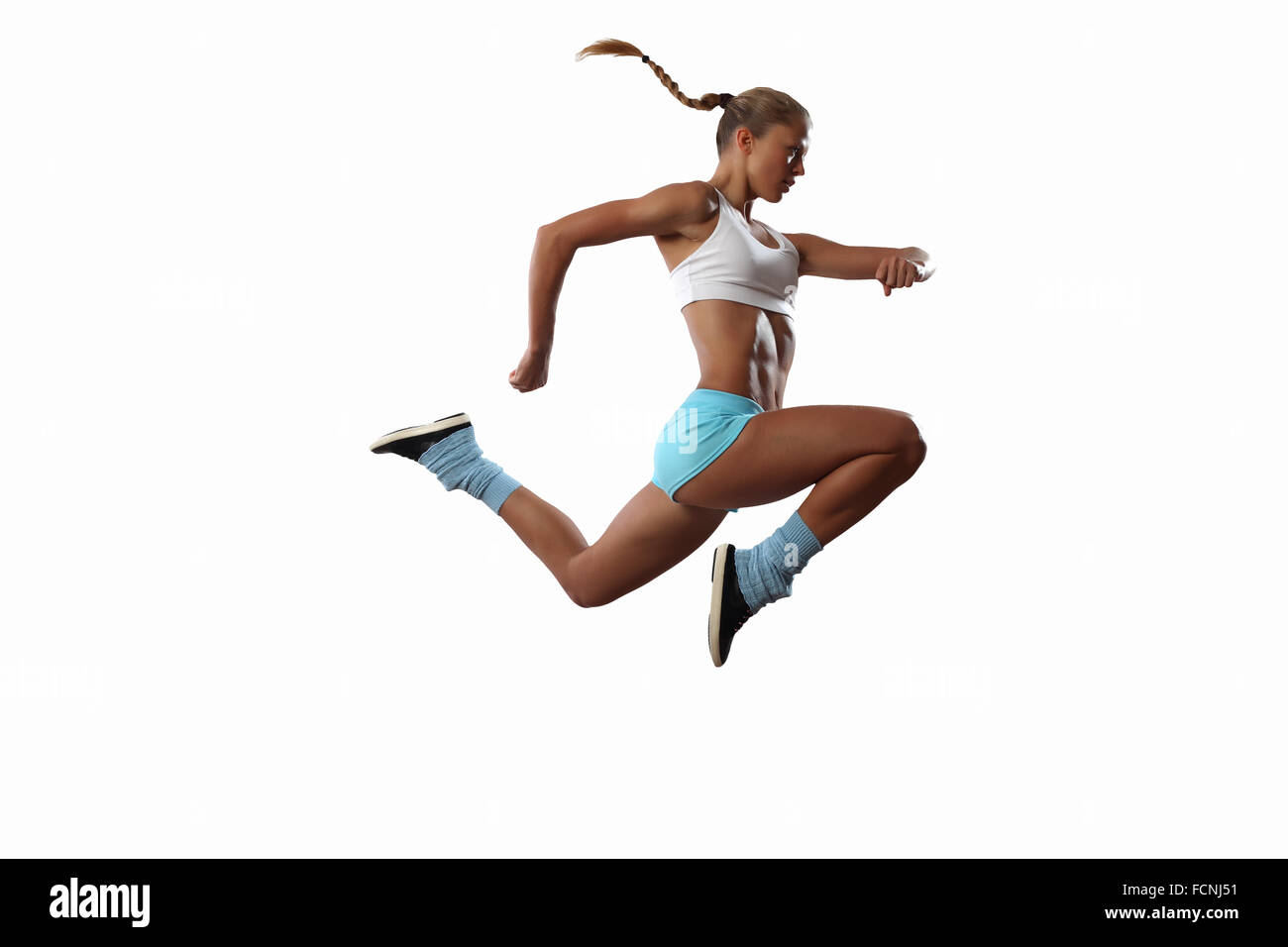 Bild von Sport Mädchen im Sprung vor weißem Hintergrund Stockfoto