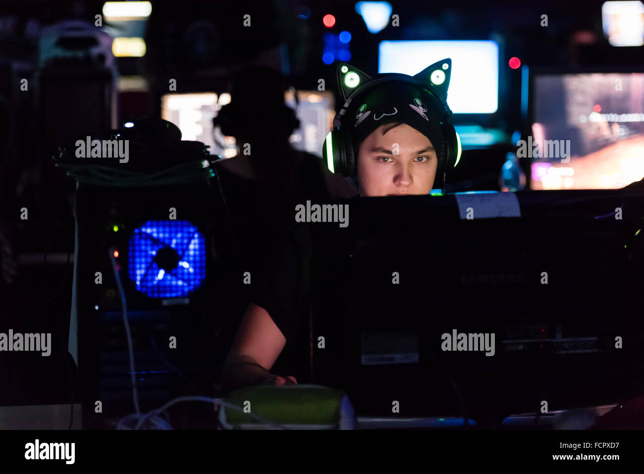 Ein konzentrierter Computer-game-Spieler schwach beleuchtet nur von seinem Computer-Bildschirm auf der größten LAN-Party der Schweiz NetGame 2015. Stockfoto