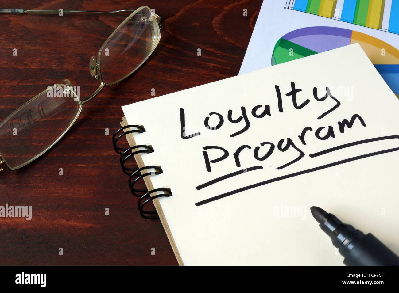 Loyalty-Programm geschrieben am Notebook mit Diagrammen. Stockfoto