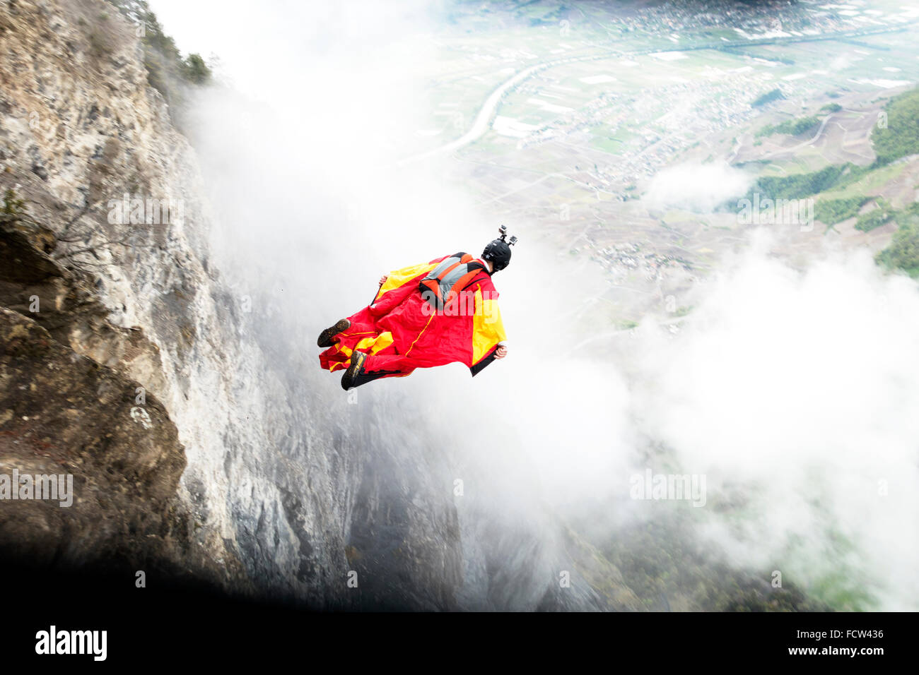 Dieses Wingsuit BASE-Jumper verlassen nur von einer Klippe hinunter ins Tal. Er werde seinen Fallschirm kurz vor Schlag den Boden öffnen. Stockfoto