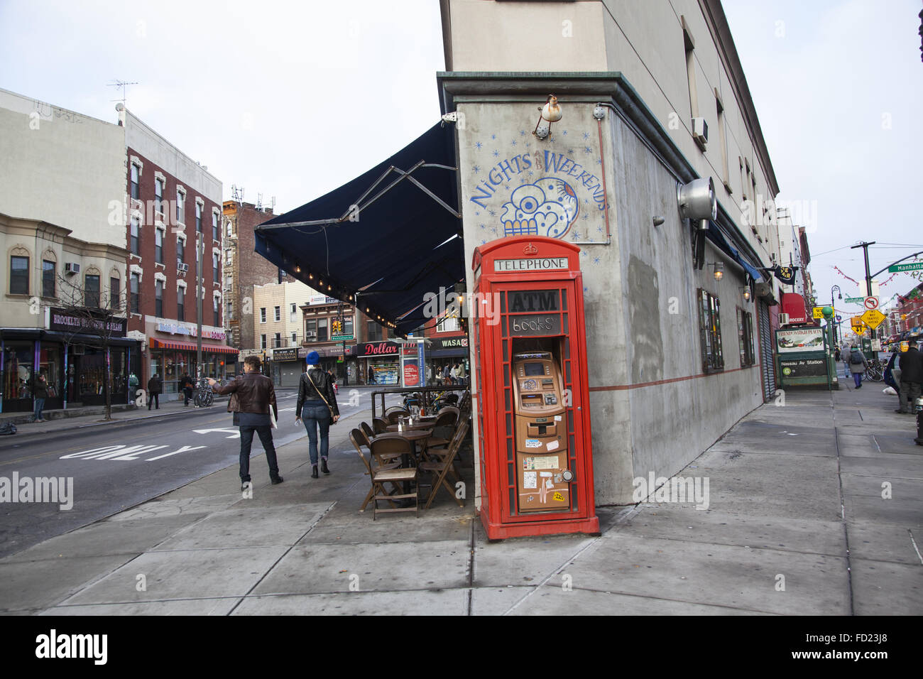 ATM, untergebracht in einem alten Telefonzelle vor einem Restaurant in Greenpoint, Brooklyn, NY. Stockfoto