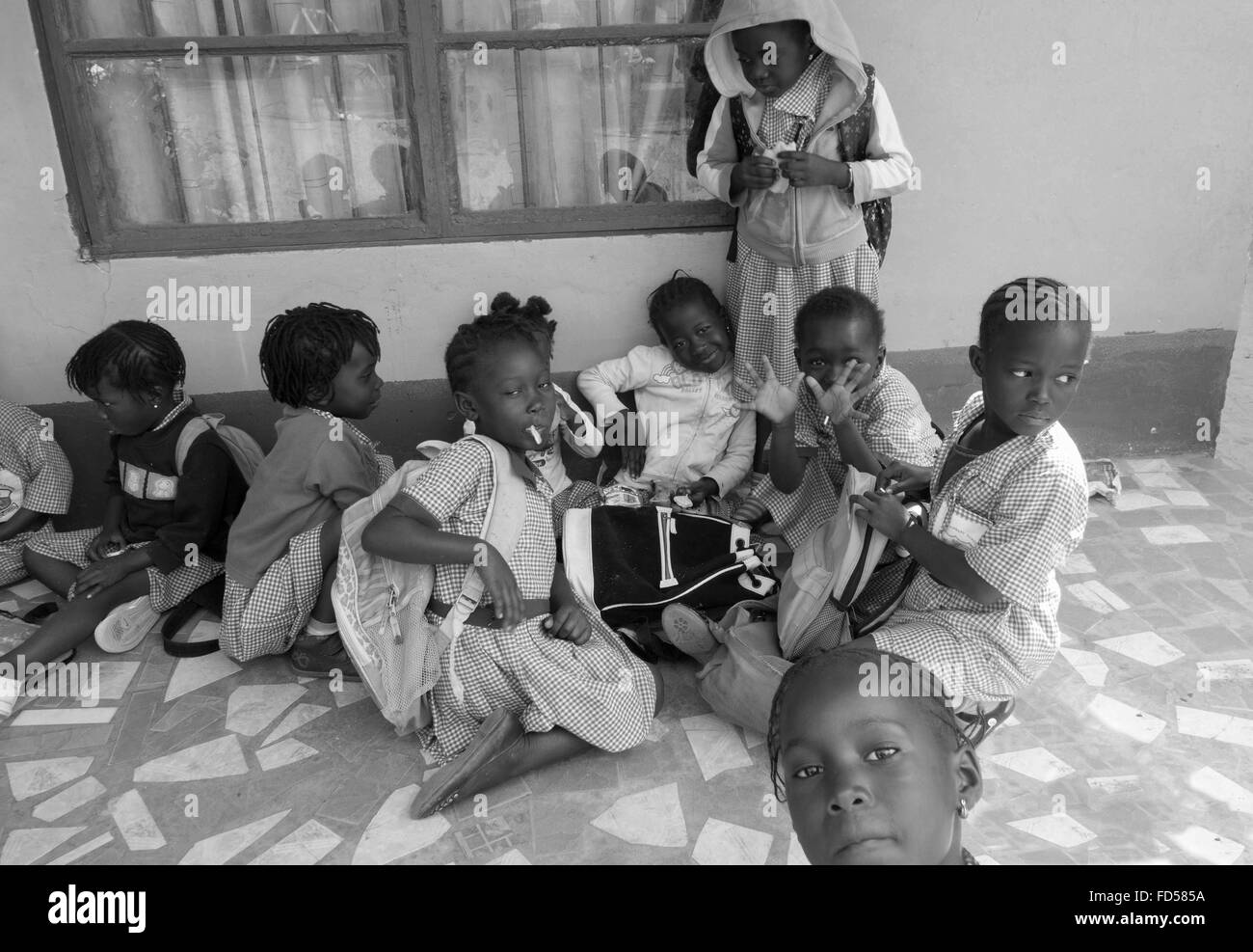 Mittagspause für schwarze Kleinkinder an einem Sponsorenlauf Schule in den Seitenstraßen von Kololi Gambia Stockfoto