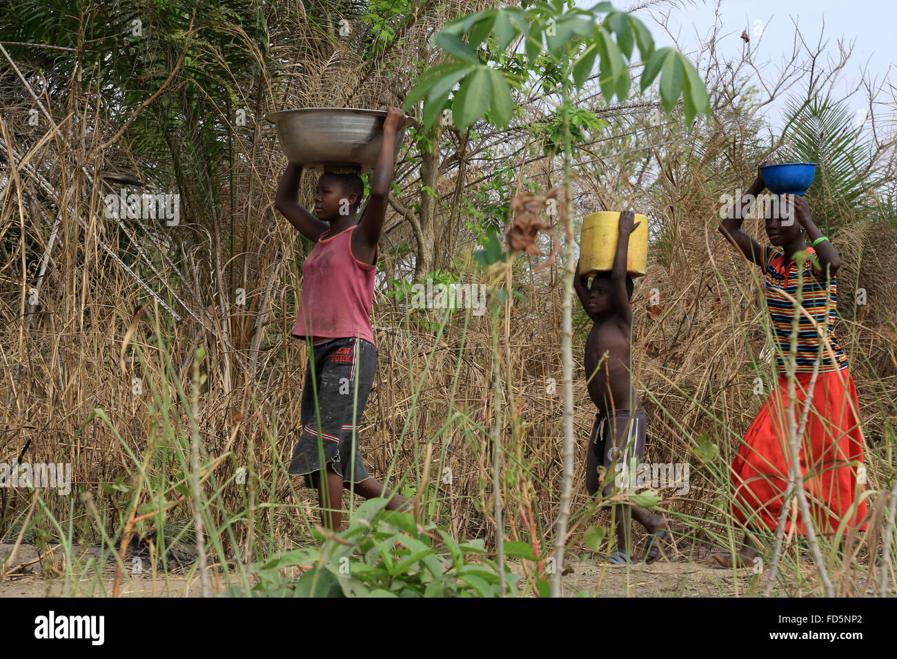 Afrikanische Kinder Wasserholen. Stockfoto
