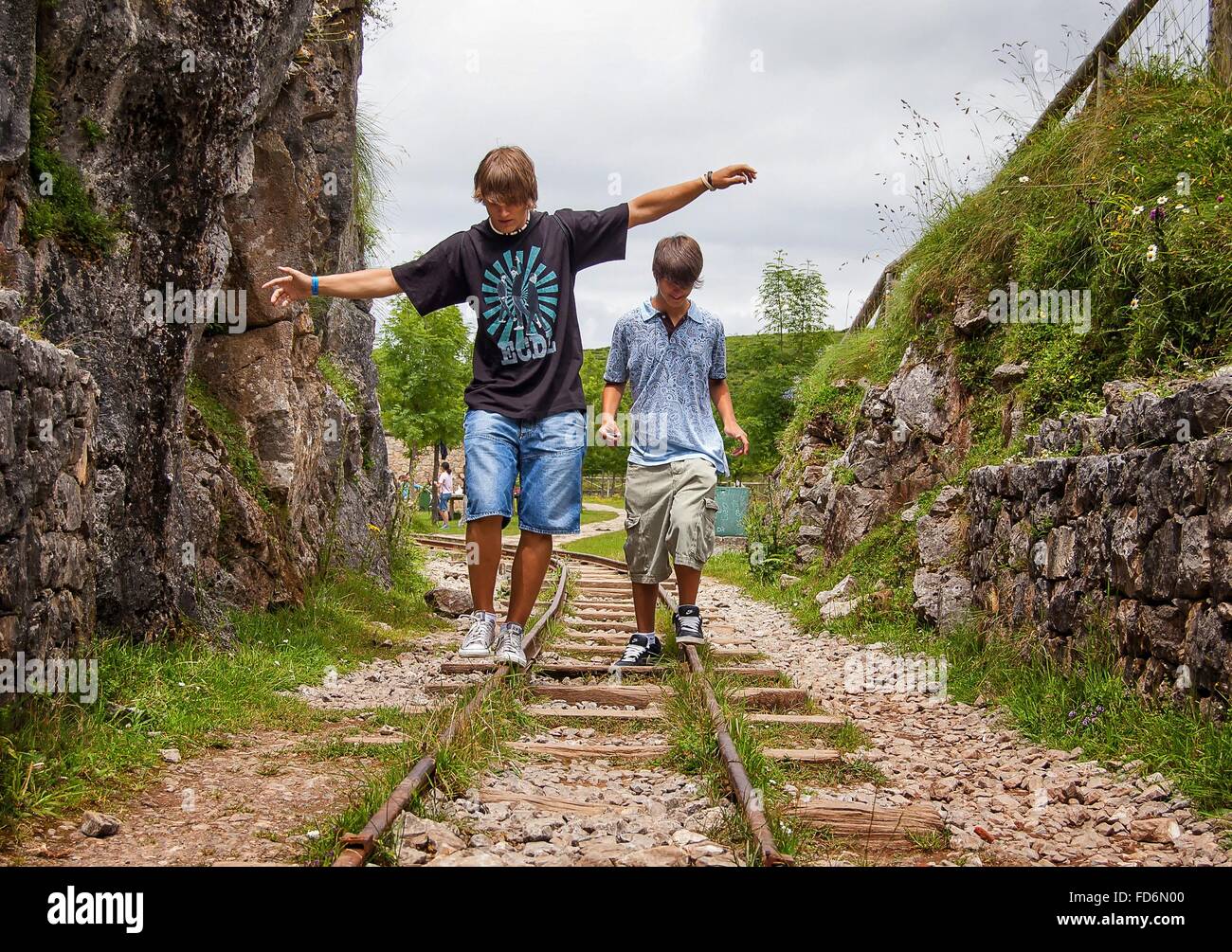Jungs im Teenageralter spielen auf Bahngleis Stockfoto