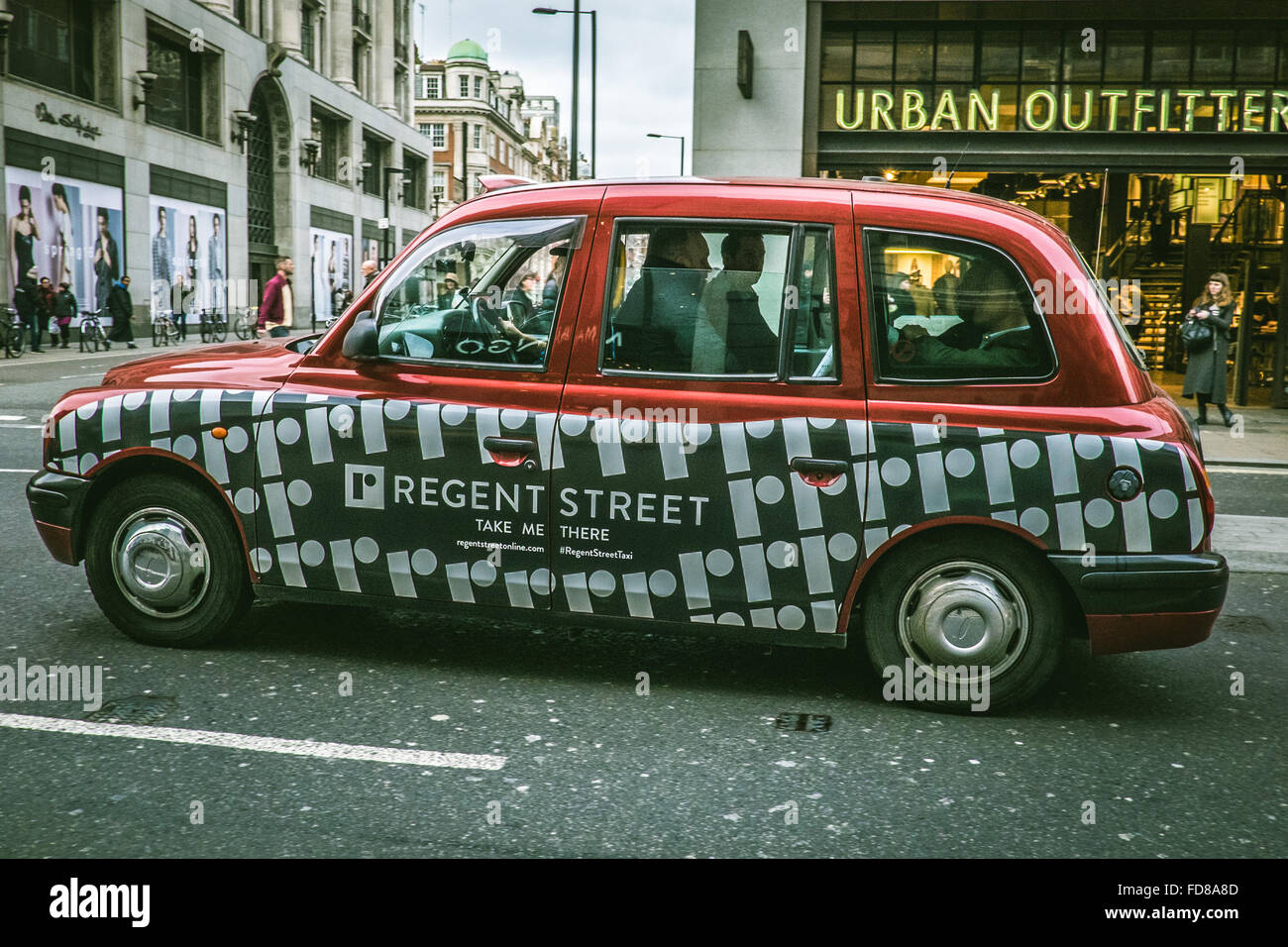 Ein London-Taxi mit roten und weißen Lackierung für Regent Street in Oxford Street Stockfoto