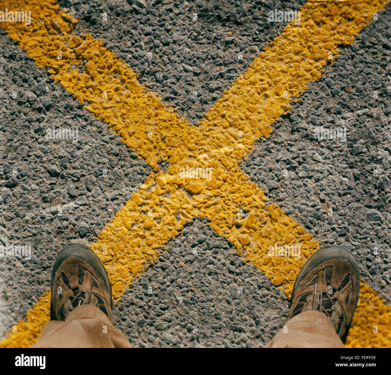 Mannes Füßen stehend auf gelben Kreuz.  Used-Effekten über Bild. Stockfoto