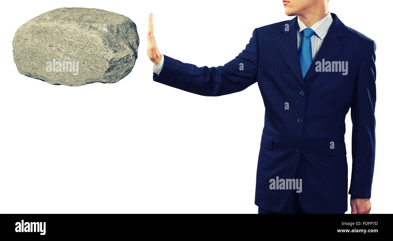 Geschäftsmann im Anzug riesigen Stein in Palm hält Stockfoto