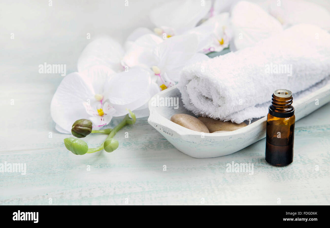 Spa-Stillleben mit weiße Orchidee und Handtuch, Bad Essenz Öl Flasche Stockfoto