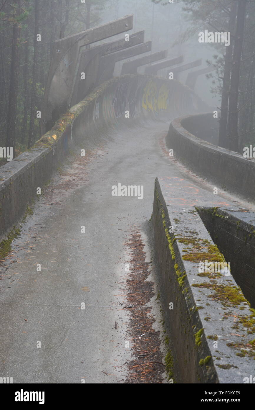 Den Krieg beschädigt Bobbahn der olympischen Winterspiele von 1984 befindet sich in den Bergen oberhalb von Sarajevo aufgegeben. Stockfoto