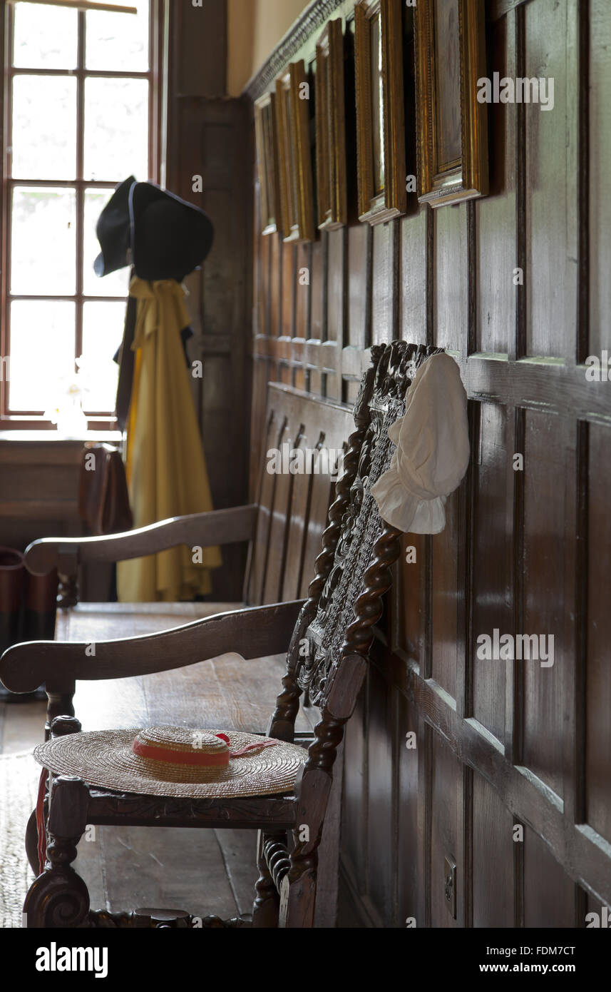 Holzvertäfelungen und Möbel in der Eingangshalle im Quebec House, Westerham, Kent. Quebec Haus war die Kindheit Zuhause von General James Wolfe. Die Hüte und Kleidungsstücke sind für Besucher zu verkleiden. Stockfoto
