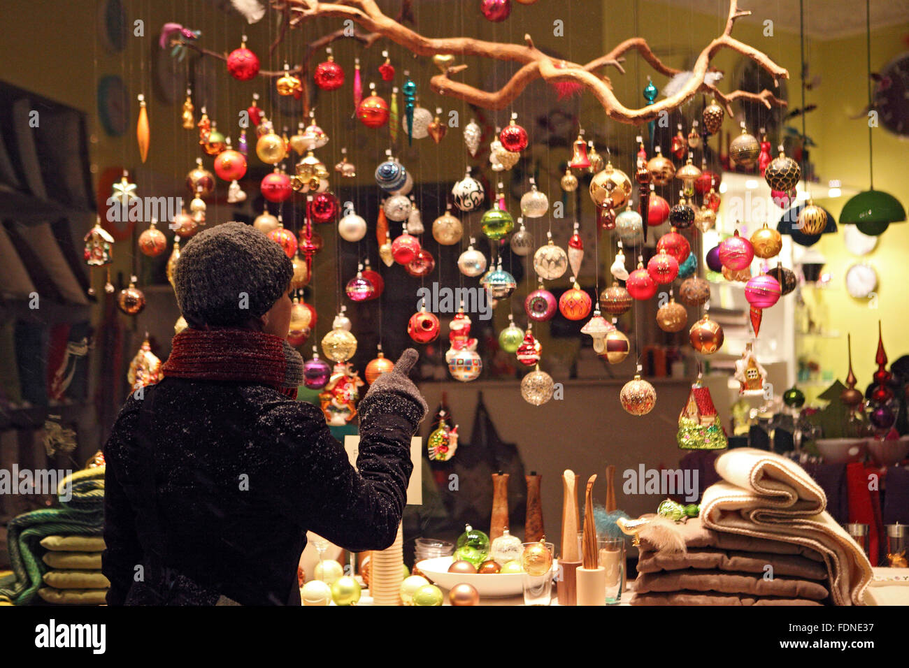 Berlin, Deutschland, Frau betrachten Weihnachtskugeln auf Stockfoto
