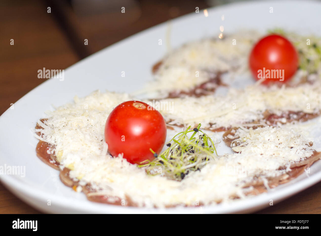 Vorspeise-Carpaccio mit Parmesan-Käse, Cherry-Tomaten und Sprossen ...
