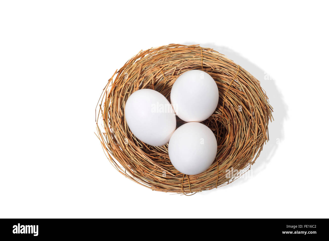Studioaufnahme von drei weißen Eiern im Vogelnest auf weißem Hintergrund Stockfoto