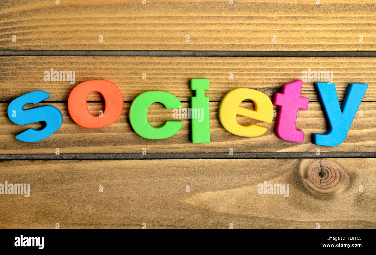 Bunte Gesellschaft Wort auf Holztisch Stockfoto