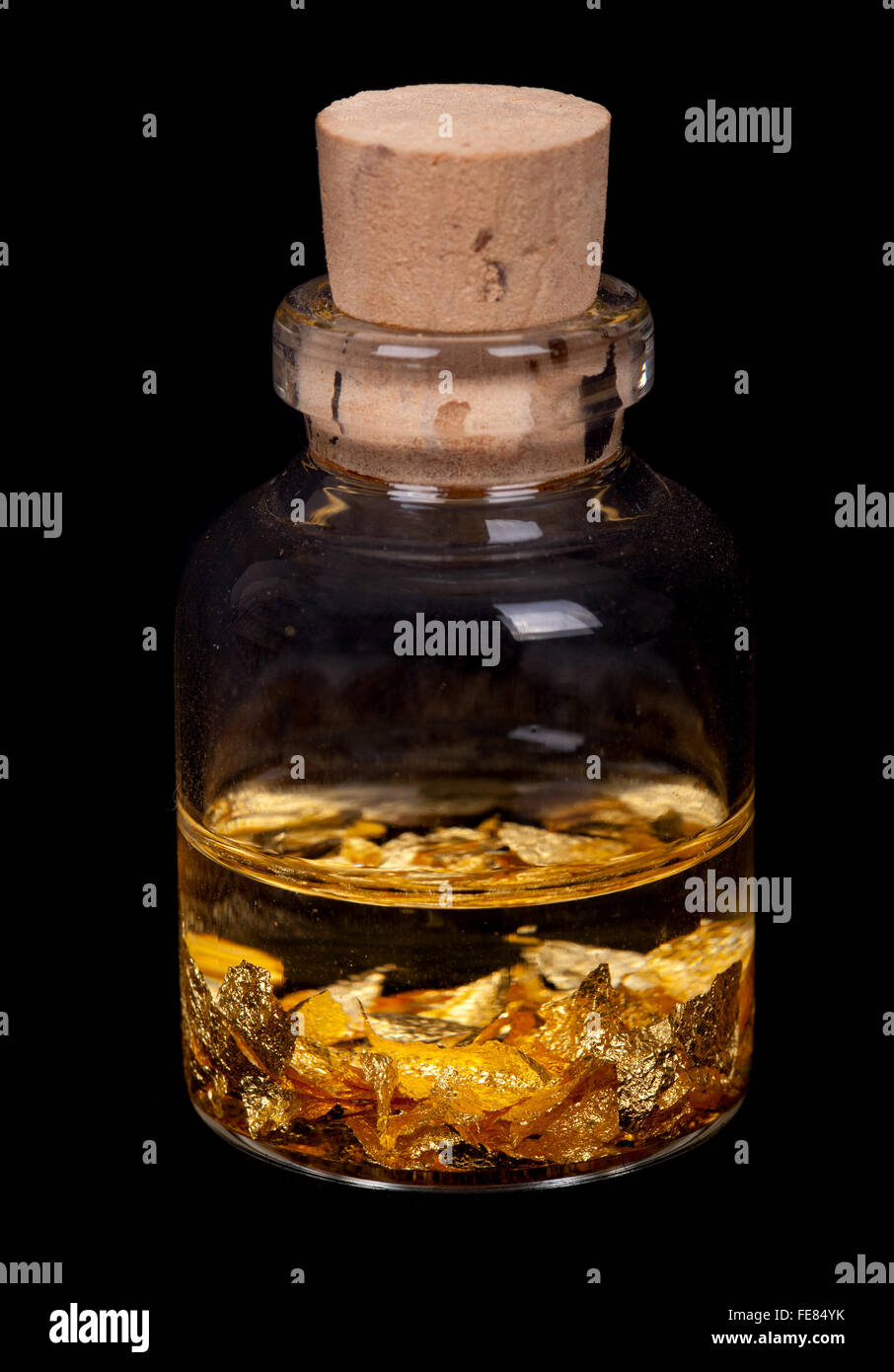 kleine Flasche mit gold Flocken Stockfoto