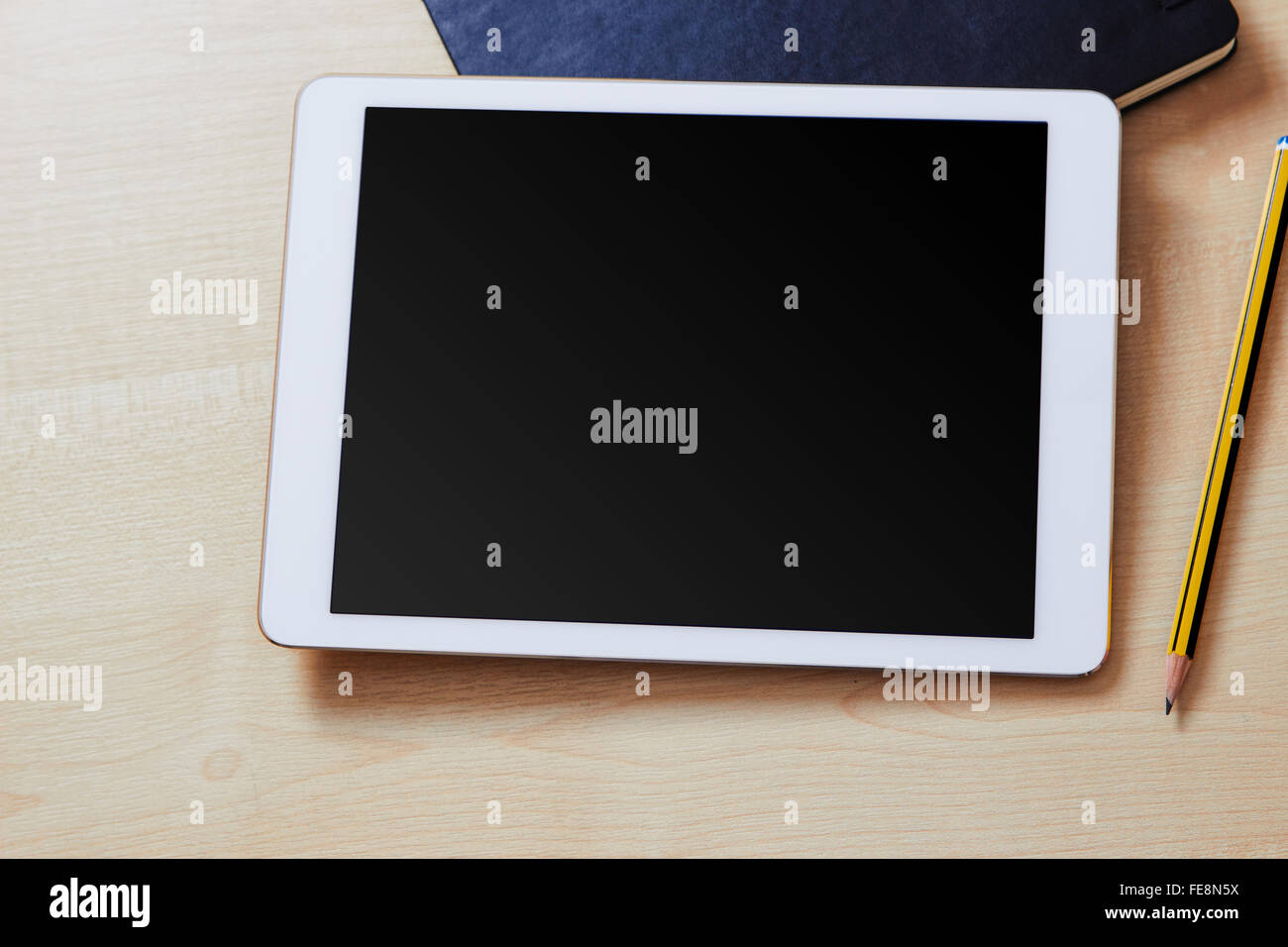 Tablet mit leeren Bildschirm auf einem Schreibtisch aus Holz und Veranstalter Stockfoto